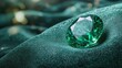 © pingpao - Stunning emerald gemstone resting elegantly on rich green fabric, highlighting beauty and luxury in a captivating setting.
