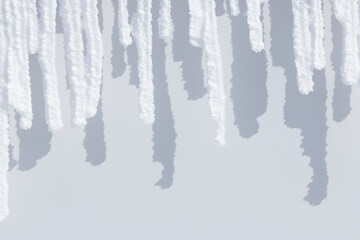Wall Mural - row of white sunlit snow icicles and shadows