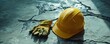 © Настя Шевчук - Image depicting a Labor Day concept with a yellow hard hat and work gloves placed on a cracked concrete surface