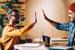 © BullRun - Prosperous creative web designers giving high five satisfied with completing project successfully, happy male employees celebrating victory or their team enjoying cooperation in office using netbooks