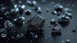 © milenialdesastudio - Close-up of scattered dark metallic crystals on a black surface.