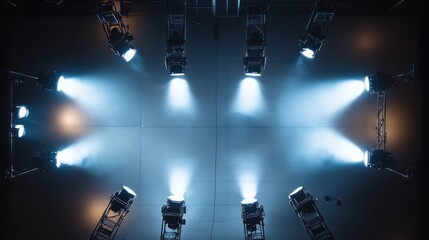 Wall Mural - Overhead view of eight stage lights illuminating a dark stage.