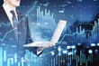 © Who is Danny - Businessman analyzing virtual financial data on laptop with upward stock chart.