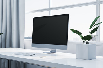 Canvas Print - Modern desktop setup with blank computer screen, keyboard, mouse, and plant near large window in bright, clean office space. 3D Rendering