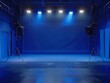 © NipaArts - Empty blue studio with lighting equipment.