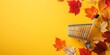 © MASJAB - Autumn Leaves Surround Small Shopping Cart On Yellow
