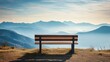 a wooden bench with mountains in the distance and morning sky