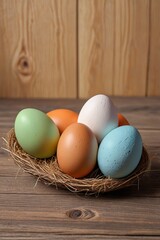 Wall Mural - there are five eggs in a nest on a wooden table