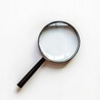 © Bersyukur Stock - A magnifying glass resting on a white surface, symbolizing examination and inquiry. isolated on white background