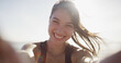 © peopleimages.com - Fitness selfie, girl and happy at beach for exercise vlog, social media post or online workout update. Athlete, person and smile with photography by ocean for training live streaming and lens flare