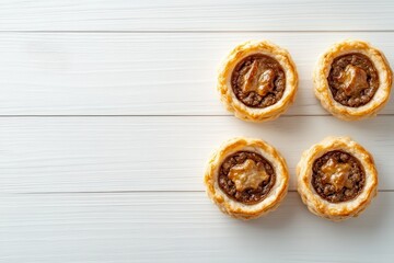 Wall Mural - Classic Aussie mini meat pies made with shortbread on a light wood surface