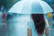 © TuruMuru - Close up of a young woman with an umbrella in the rain on a warm summer day Lifestyle perspective from behind