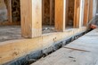 © TuruMuru - Detail shot of an acrow prop under visible wooden floor joists in a remodeled home