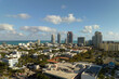 Aerial view of South Beach sandy surface with tourists relaxing on hot Florida sun. Miami Beach city with high luxury hotels and condos. Tourism infrastructure in southern USA