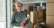 © peopleimages.com - Woman, tablet or portrait in business for logistics, order process or checklist at window. Mature supplier, tech or happy in warehouse for inventory management app, supply chain or boxes for delivery
