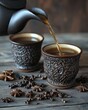 © Zoe - Dark teapot pouring tea into ornate cups, surrounded by star anise and peppercorns on rustic wood.