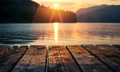 Wall Mural - wooden pier at sunset with calm lake and mountains in background