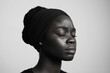 © Andrii Zastrozhnov - A woman with a black head scarf and a white background. She has a black face with a white powder on it