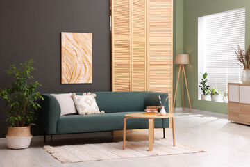 Aufkleber - Soft sofa, houseplant and coffee table near black wall in stylish living room