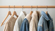 © bephoto - 木製ハンガーにかけられた多彩な衣類