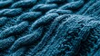 © Anna - textured blue knit fabric with braided patterns, showcasing intricate detailing and a soft, cozy aesthetic for a warm and stylish design