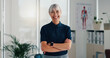 © peopleimages.com - Woman, physiotherapist and portrait in office with confidence, career pride and healthcare service. Mature chiropractor, happy and about us in practice for reflexology, arms crossed and physiotherapy