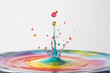 © agnes - A vivid water droplet splashes into a reflective surface creating a mesmerizing ripple effect with colorful suspended droplets mid-air
