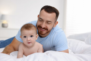 Wall Mural - Father with his cute baby on bed at home