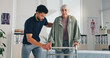 © peopleimages.com - Senior woman, physical and help with walker for support, injury or arthritis at clinic. Patient, therapist and healthcare with walking frame, rehabilitation and recovery of muscle in osteoporosis