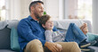 © peopleimages.com - Happy dad, child and relax with hug on sofa for holiday, bonding or weekend together at home. Parent, son or kid with smile or laugh for funny entertainment, comedy or fathers day on couch at house