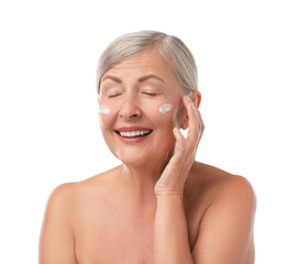 Wall Mural - Senior woman with face cream on white background