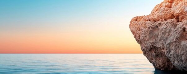 Poster - A serene seascape featuring calm waters, a rocky shore, and a vibrant sunset sky blending hues from orange to blue.