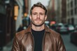 © Viktor - Handsome young man in city streets. Casual attire. Leather jacket. Stylish urban look. Modern style. Guy stands confidently. Urban backdrop. Possible daytime twilight. Photogenic, serious expression.