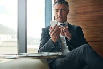 Business, chair and phone with mature man in professional workplace for communication or networking. App, social media and text message with corporate employee in office for mobile post or update