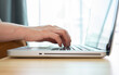 © boyloso - Cropped shot view of woman hands while typing on laptop computer.