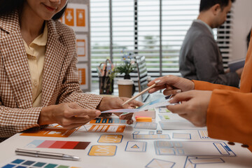 Wall Mural - ux developer and ui designer brainstorming about mobile app interface wireframe design in the office
