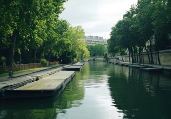 Wall Mural - Calm canal scene with docked boats and lush trees.