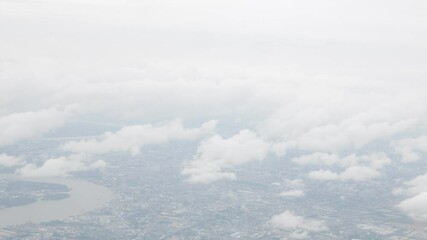 Wall Mural - view from plane over blue sky with white Fluffy clouds while flying through in sunny summer time.nature blue sky cloud and sun for Clean Environment, save energy or transportation holiday concept.