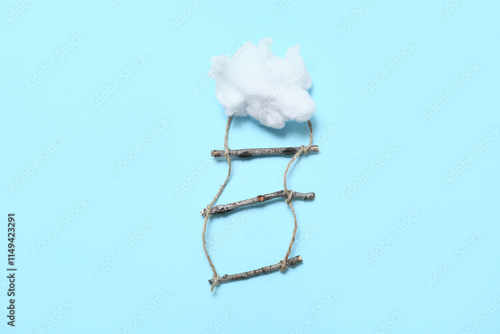 Ladder and cotton cloud on blue background