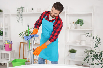 Wall Mural - Male janitor cleaning faucet in bathroom