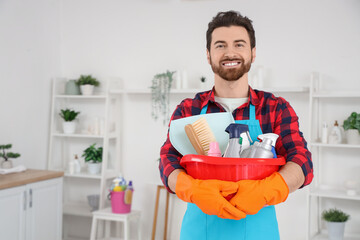 Wall Mural - Male janitor with basin of cleaning supplies in bathroom