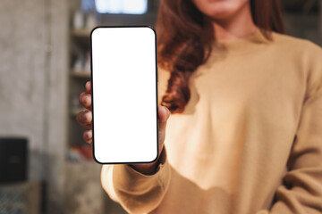 Wall Mural - mockup image of a woman holding and showing mobile phone with blank white screen