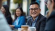 © AndiAzis - Man Smiles Joyfully During Coffee Break, Casual Meeting with Friends Outdoors, Enjoying Conversation and Drinks.