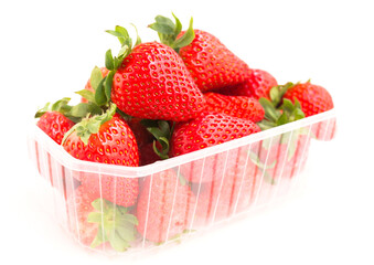 Wall Mural - Fresh appetizing strawberries in a plastic tray onwhite background