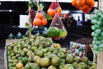 Wall Mural - Green sweet oranges in a fruit shop are suitable for use in poster designs, or as illustrations for articles about fruits.