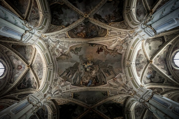 Wall Mural - The ceiling of a church is covered in gold leaf and has a very ornate design