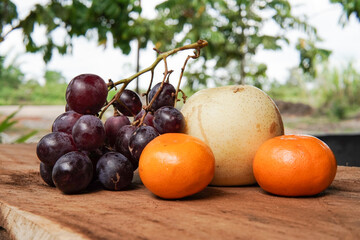 Wall Mural - The concept of Tangerine or Mandarin orange with Grapes and Pears on a white background is suitable for design needs, as an illustration for articles about fruits and others.