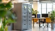 © Athirat - A tall, metal filing cabinet with locking drawers, placed in a shared office space.