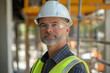 © Emily88 - An engineer wearing a hard hat, reflective safety vest, and safety glasses o on a construction background