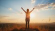 © Aleks - Woman celebrating sunrise with raised arms on mountain top